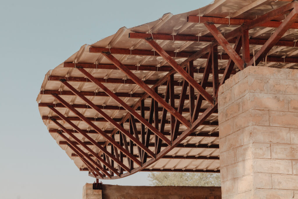 Earth, Truss and Clerestory: The Structural Grammar of Climate-Conscious Community Buildings in Africa