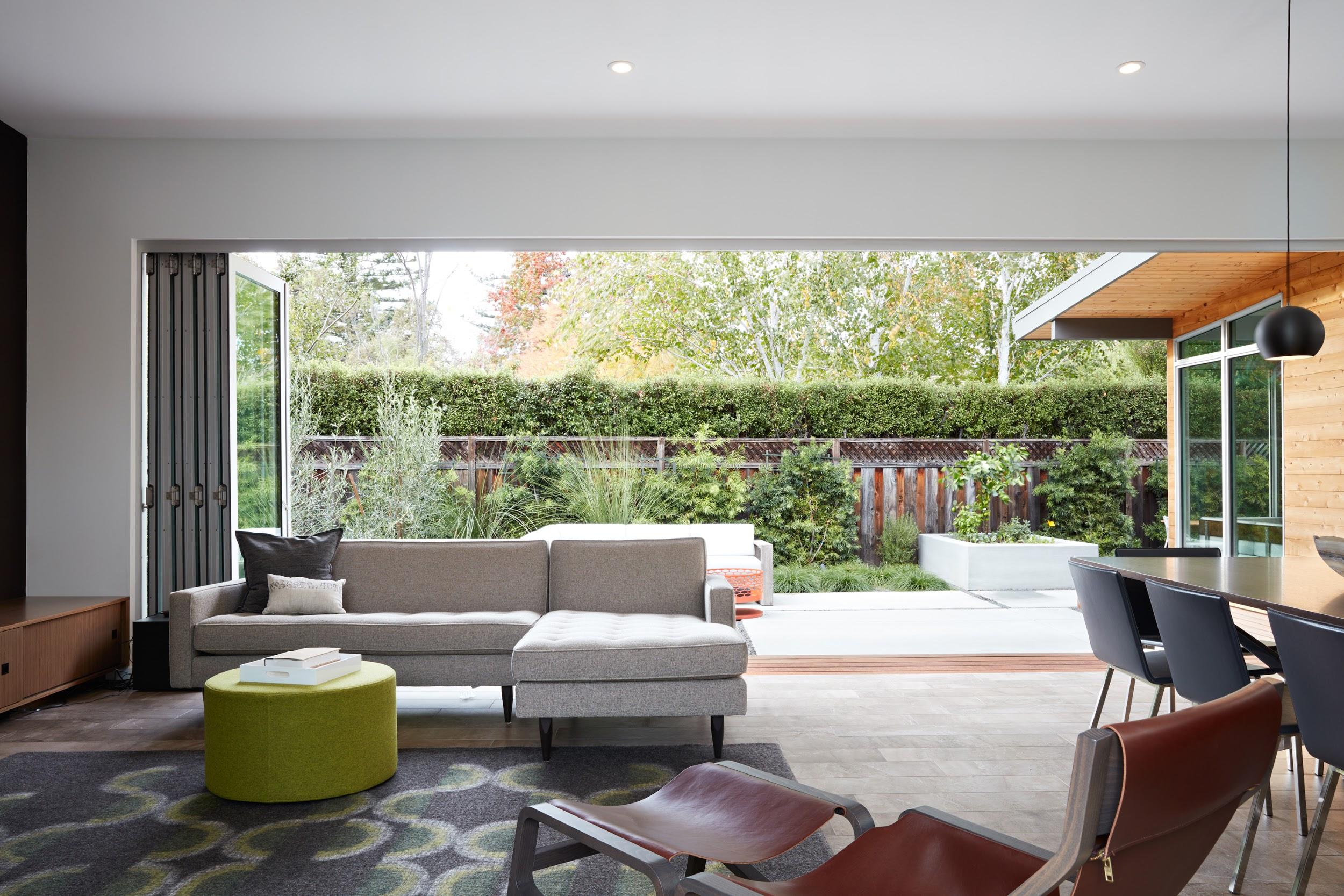 The Series 7950 Aluminum Bi-Fold Door from Western Windows opening onto a living room