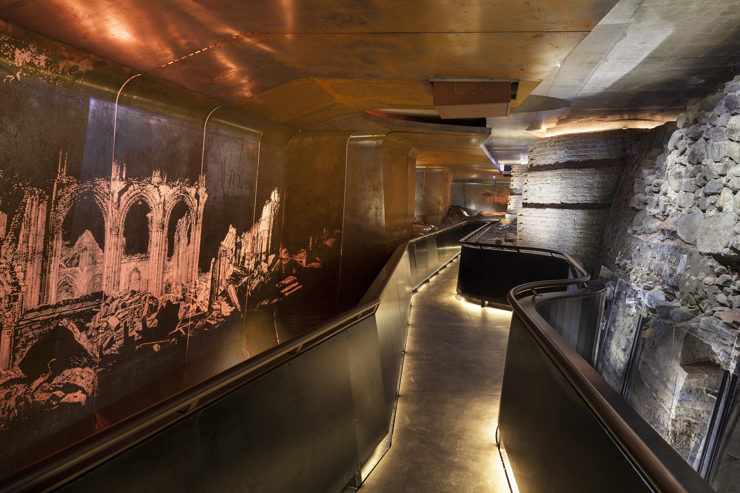 A narrow path and interactive multimedia displays on the walls of DOMunder by Tinker imagineers