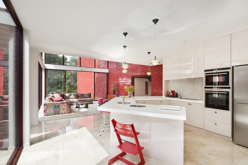 Finn House interior view of kitchen with red glazed bricks