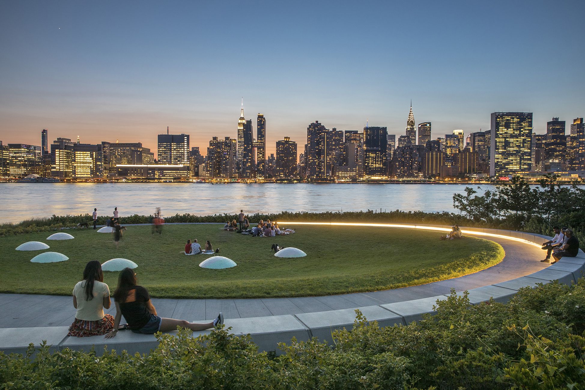 A circular green area in use as part of the Hunter's Point South Waterfront Park.