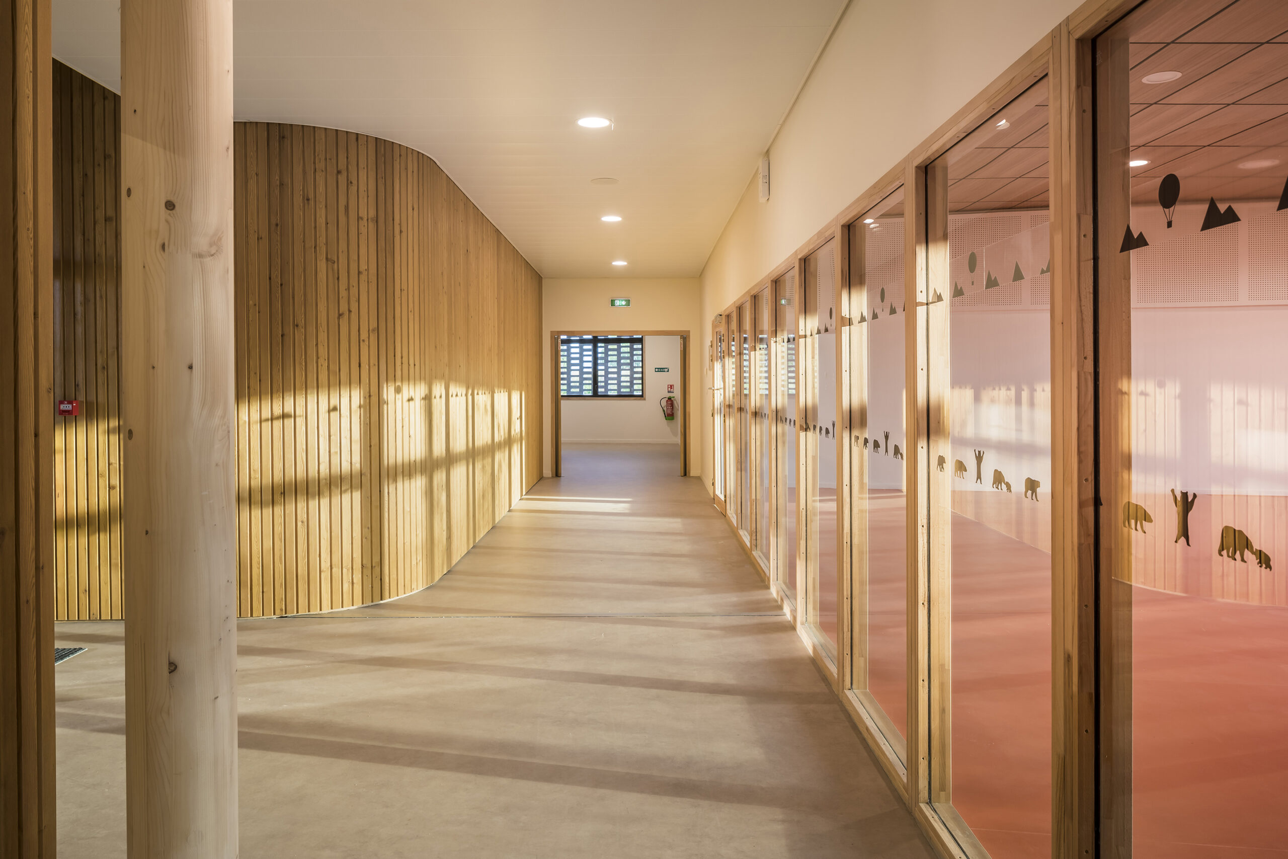A close up shot of the school's interior, showing wooden cladding and window frames. 