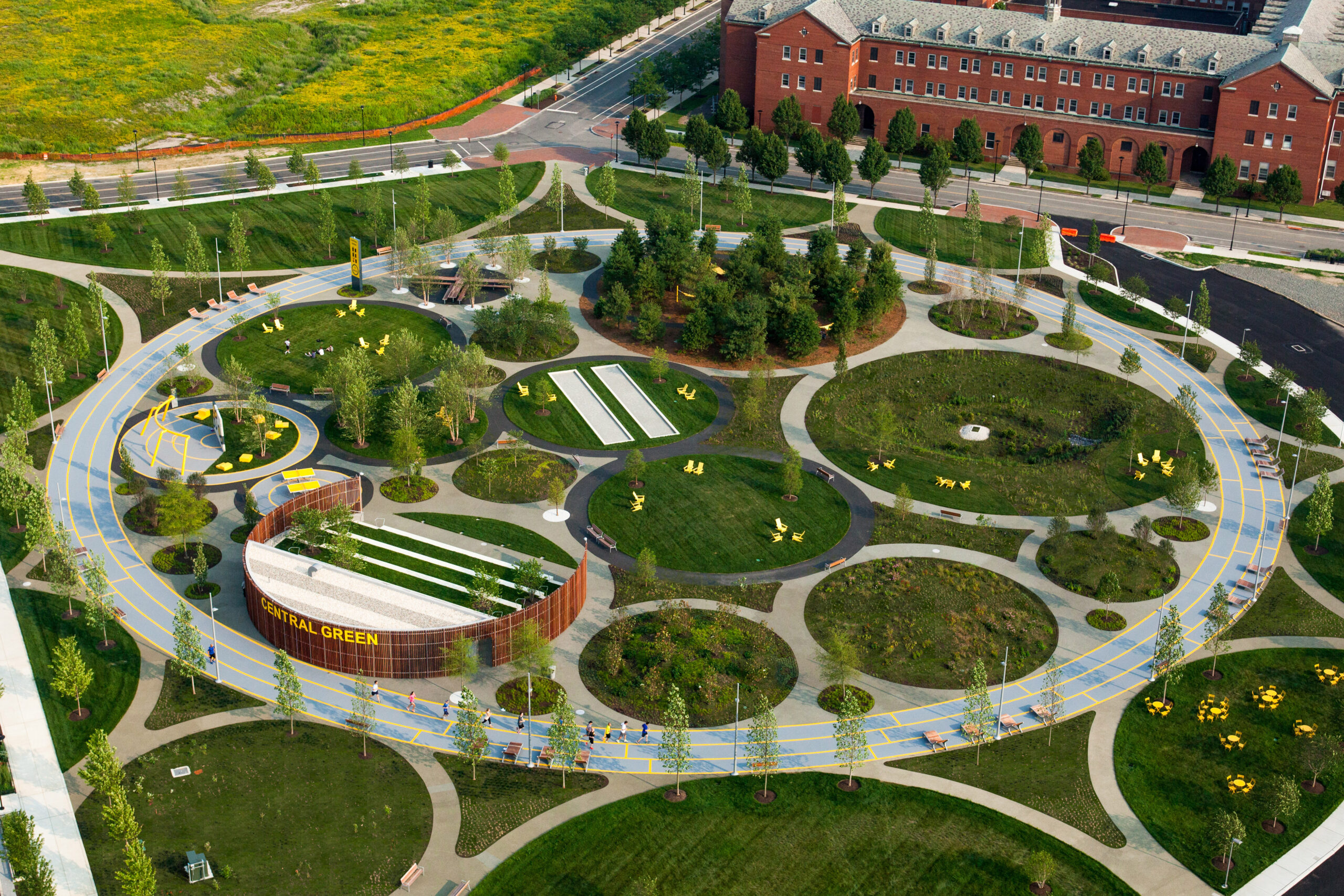A semi-areal view of the Navy Yard Central Green, showcasing various activity zones offered by the public space.