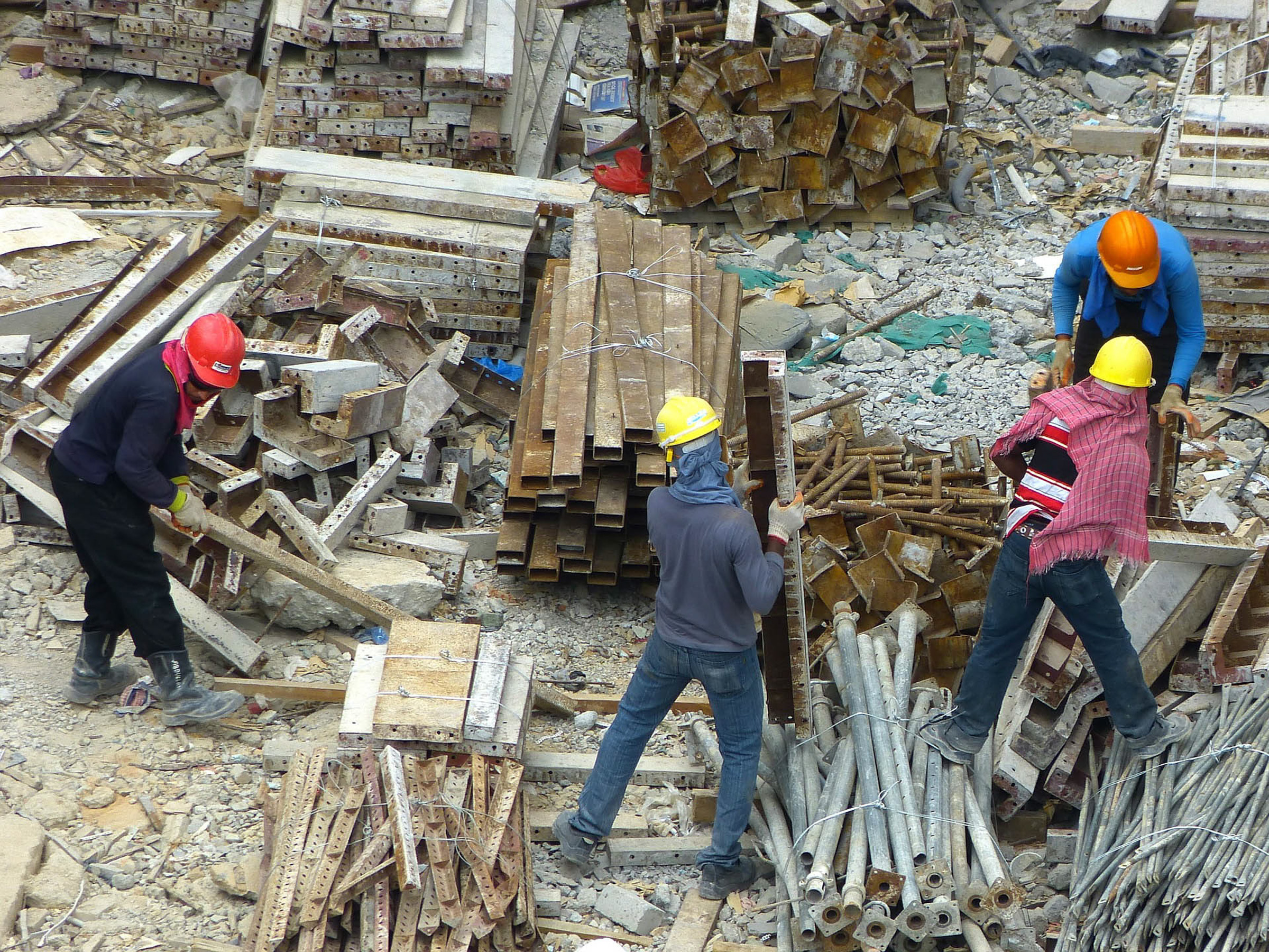 Group of people around a pile of rubble